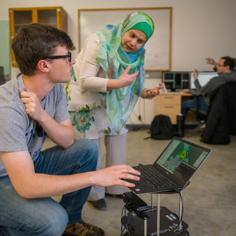 two people looking at laptop