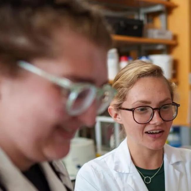 two students in lab coats