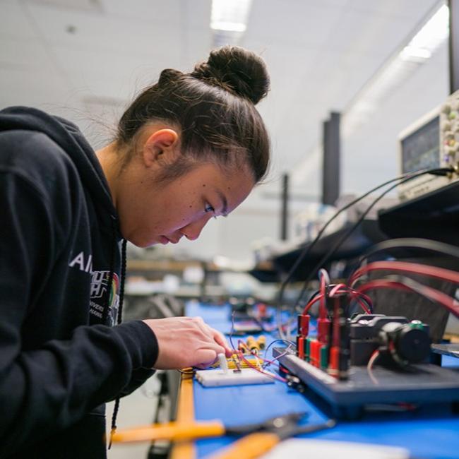 student working on electrical equipment