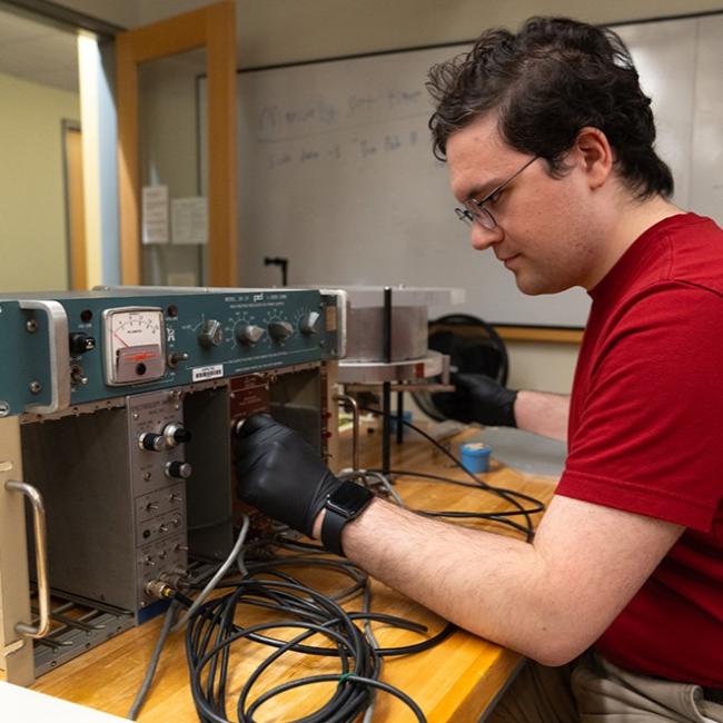 physics student working on equipment