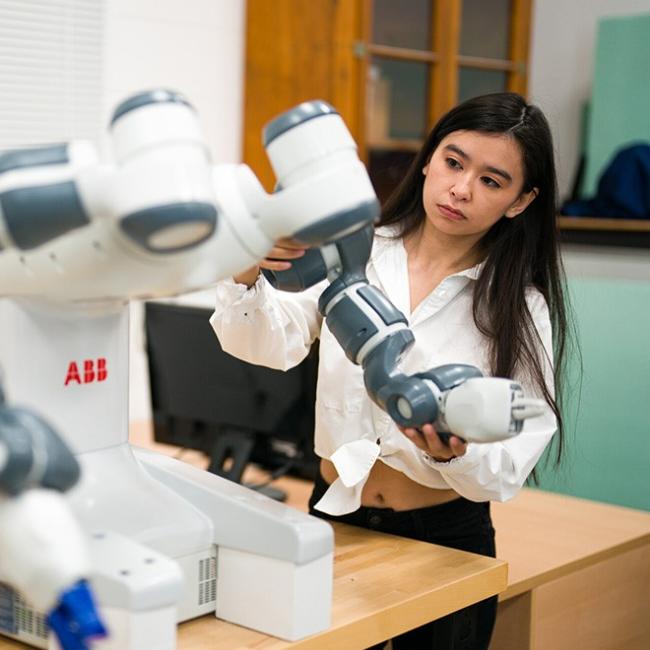 Woman working on robotics equipment