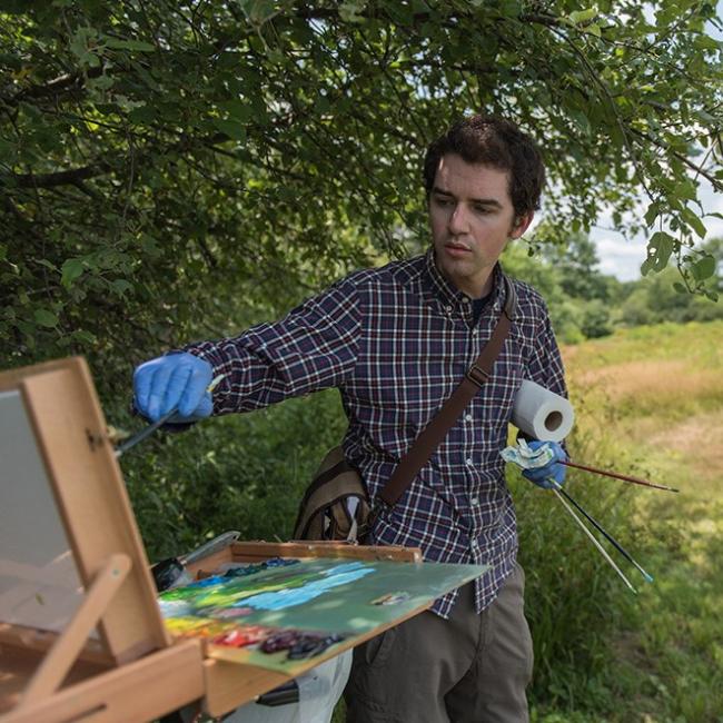 student painting outside