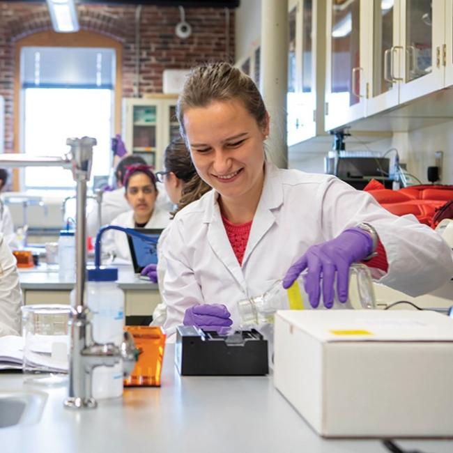 female student in lab coat
