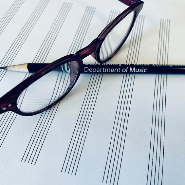 Glasses and a pencil that reads Department of Music