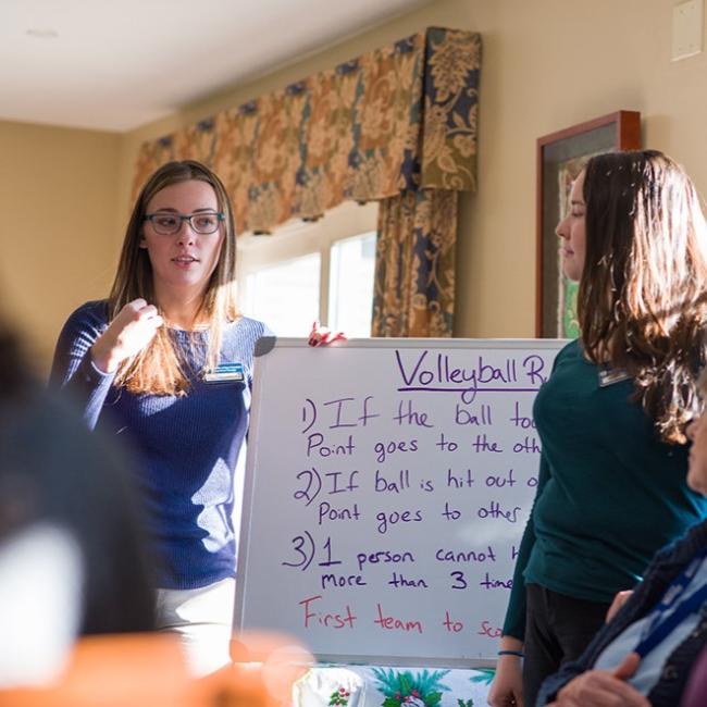 Two students standing at a whiteboard
