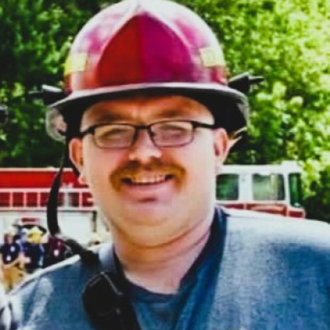 photo of a male firefighter with a safety helmet on