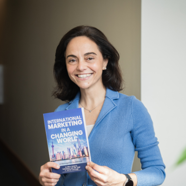 Billur Akdeniz poses at Paul College with her new book “International Marketing in a Changing World: A Managerial Guidebook.”