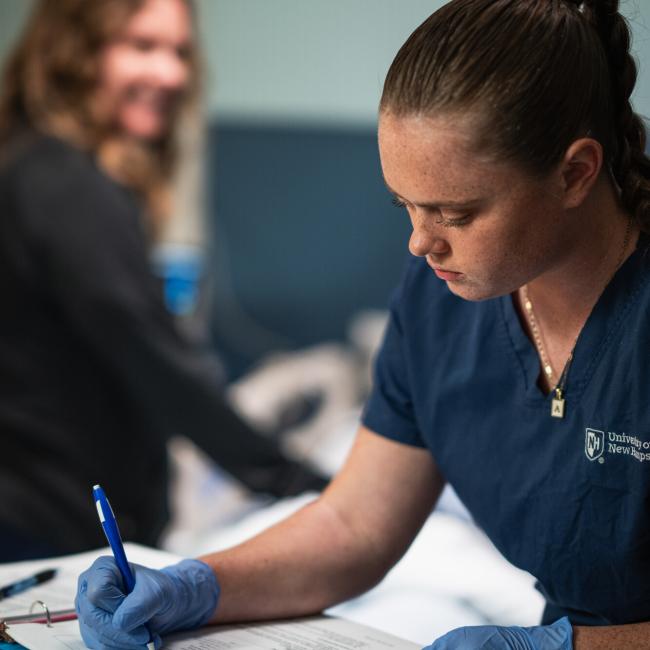 Female nursing student taking notes
