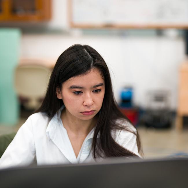 UNH computer science student working at a computer