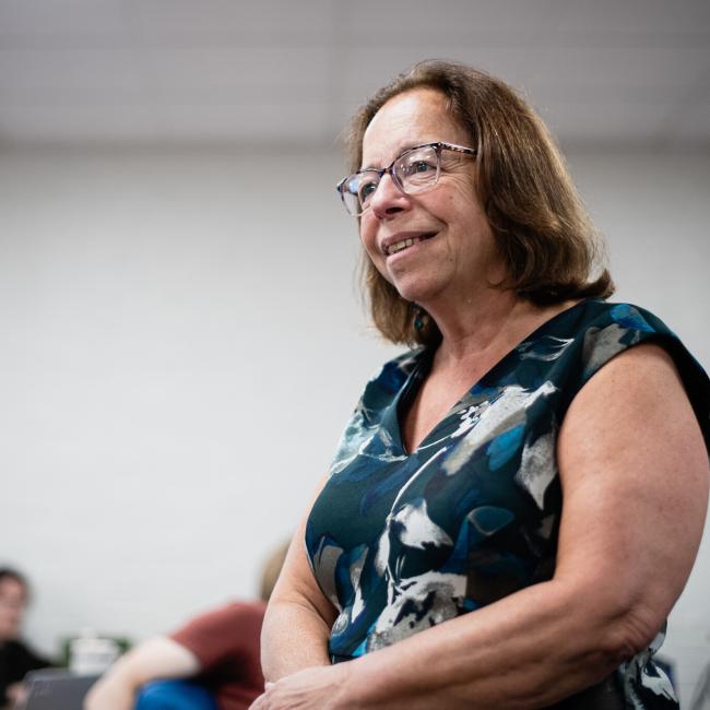 UNH professor standing during a classroom lecture