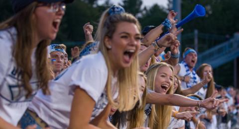 students cheering at UNH football game