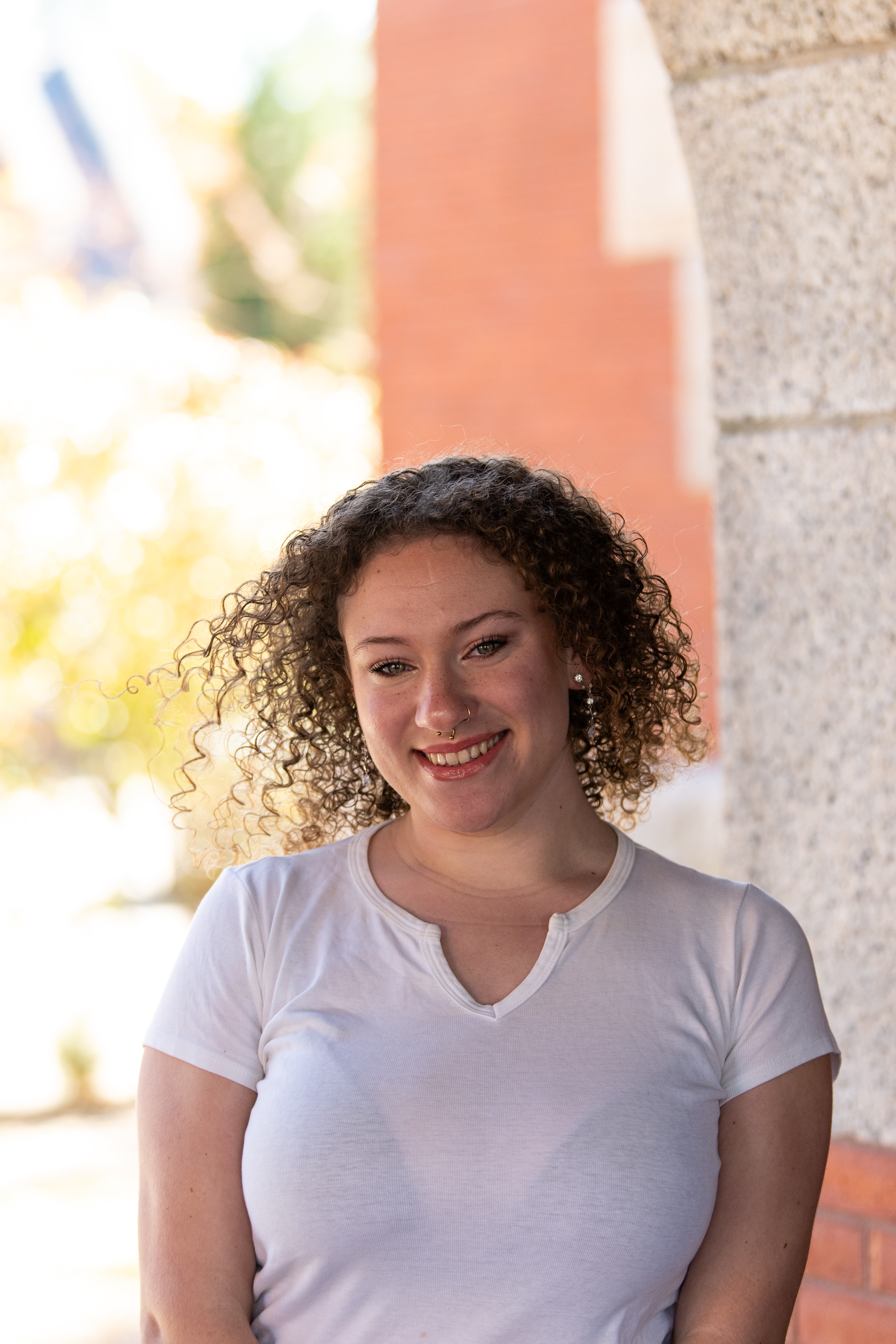 a young white woman with long blonde curly hair