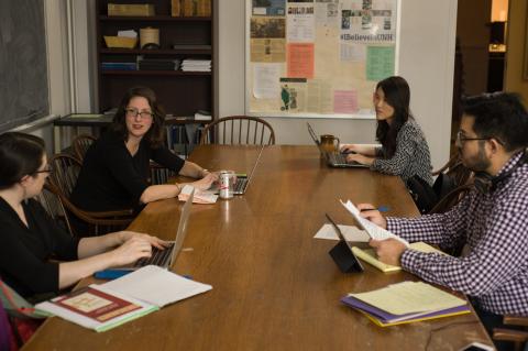 Discussion around a table with reference materials