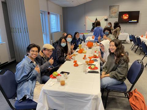 CONNECT students participating in a pumpkin decorating social