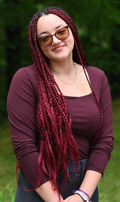 McNair scholar, professionally dressed, wooded backdrop