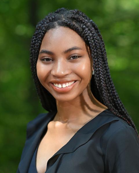 woman smiling, black blouse, outside