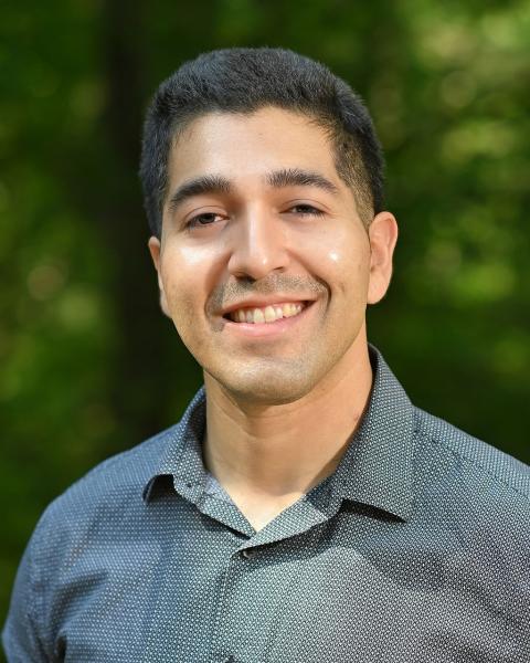 Male smiling, outside, polo shirt