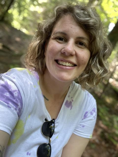 a young white woman with curly blonde hair