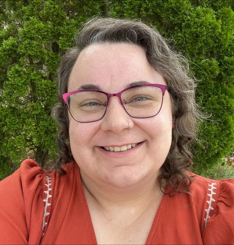 a young white woman with short brown hair and glasses