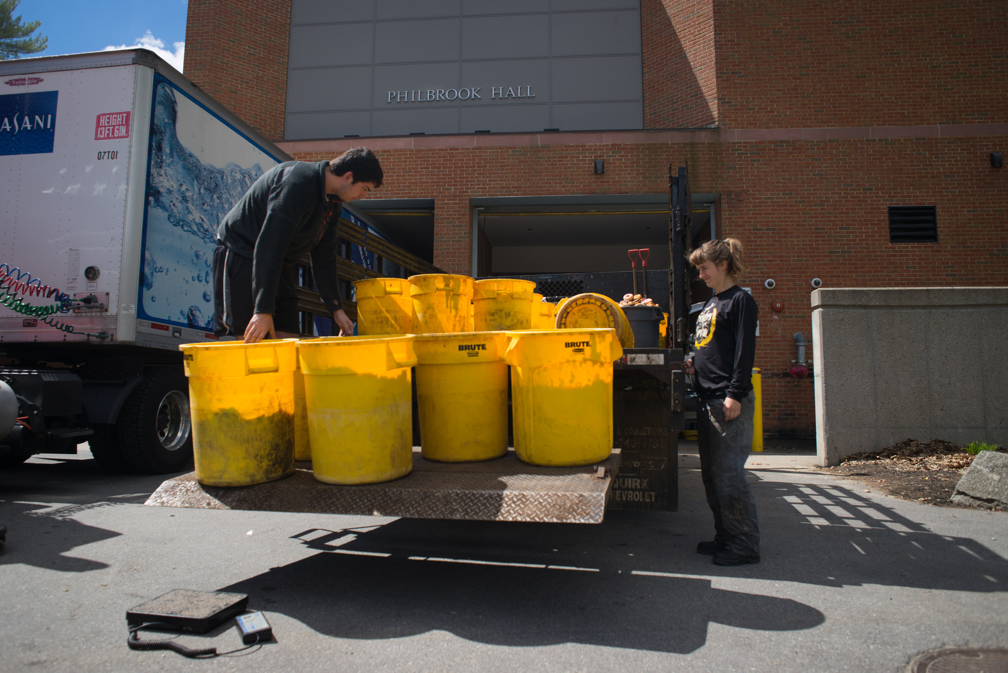 students collecting food to be composted in buckets