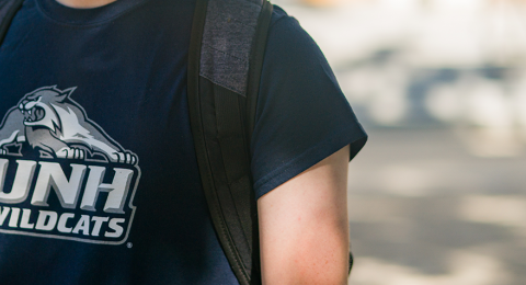 student in UNH branded tee 