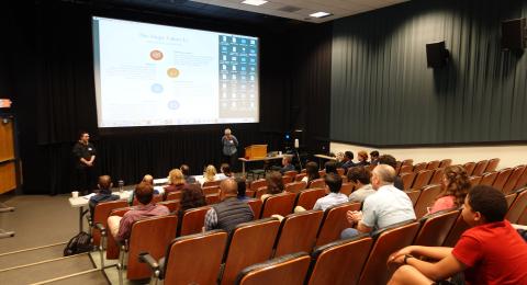 Student presenting to an audience in an auditorium
