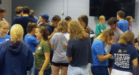 students gathered together at an event talking with one another