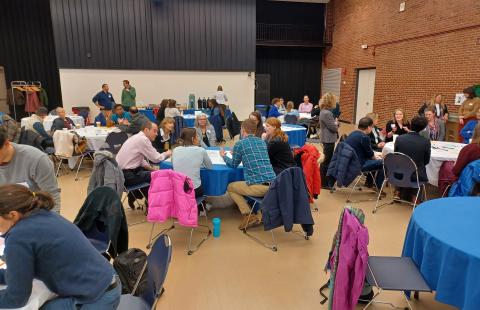 people seated at tables in a large room