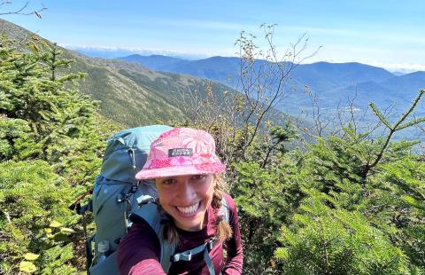 Zara taking a selfie on a mountain