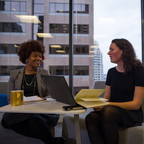 student working with mentor at a table