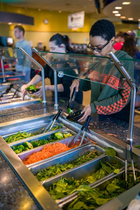 student getting food in the dining hall