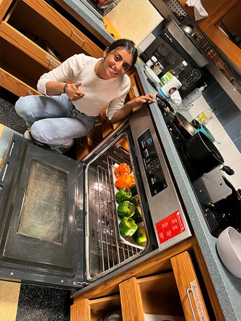 student at stove cooking