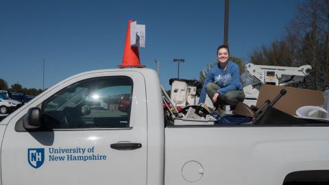 Student sits in truck on top of donated items from t2t