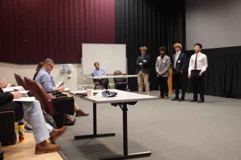 students presenting to a panel of judges