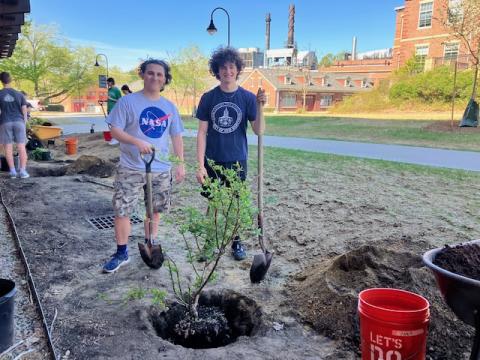 two people planting in a garden