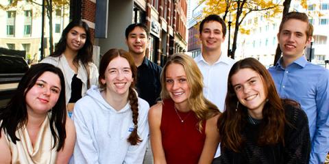 group of students standing outside together in the city