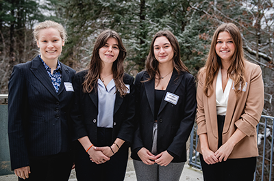 four students standing outside