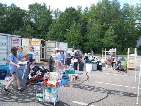 Volunteers sort clothing and trashcans
