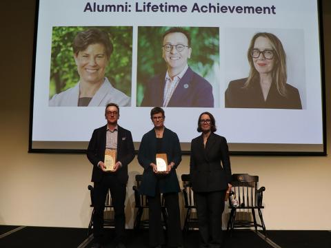 people on stage holding awards