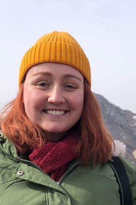 Kelsey outside with mountains in the background