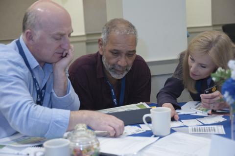 three UNH Faculty members working together during workshop