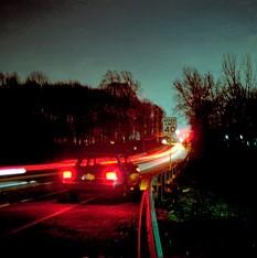 Car taillights at night.