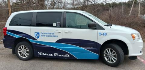 Blue and white Access Van parked on campus.