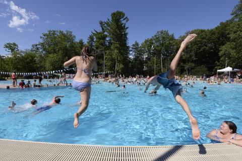 Kids diving into the UNH outdoor pool.