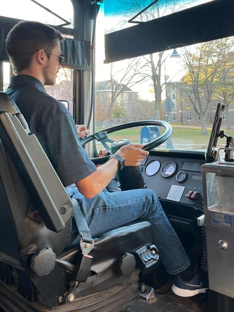 Driver behind the wheel of the bus.