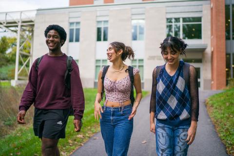 Three students walking outside talking