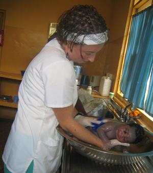 Ashley Barbour bathing a child.