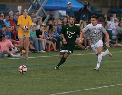 UNH men's soccer player and opponent