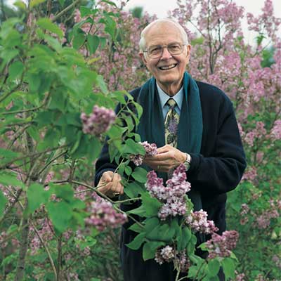 UNH emeritus professor of plant biology Owen Rogers among lilacs