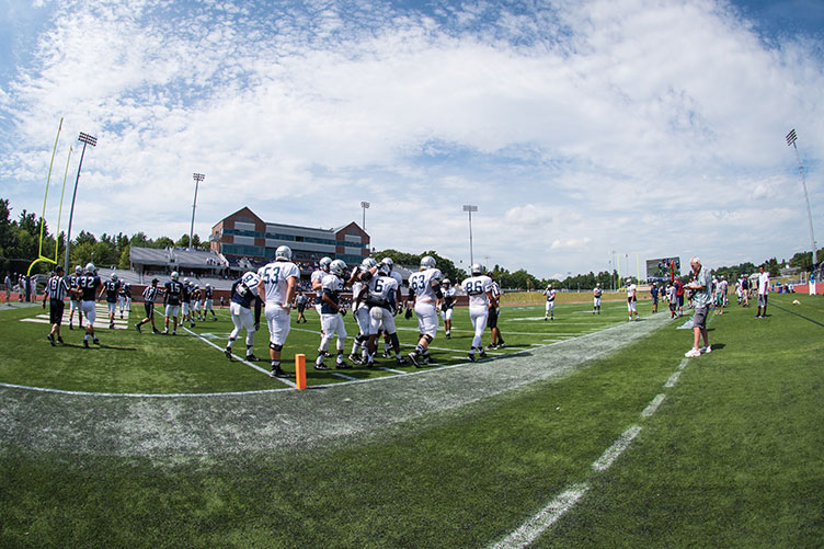 UNH football players practicing at Wildcat Stadium